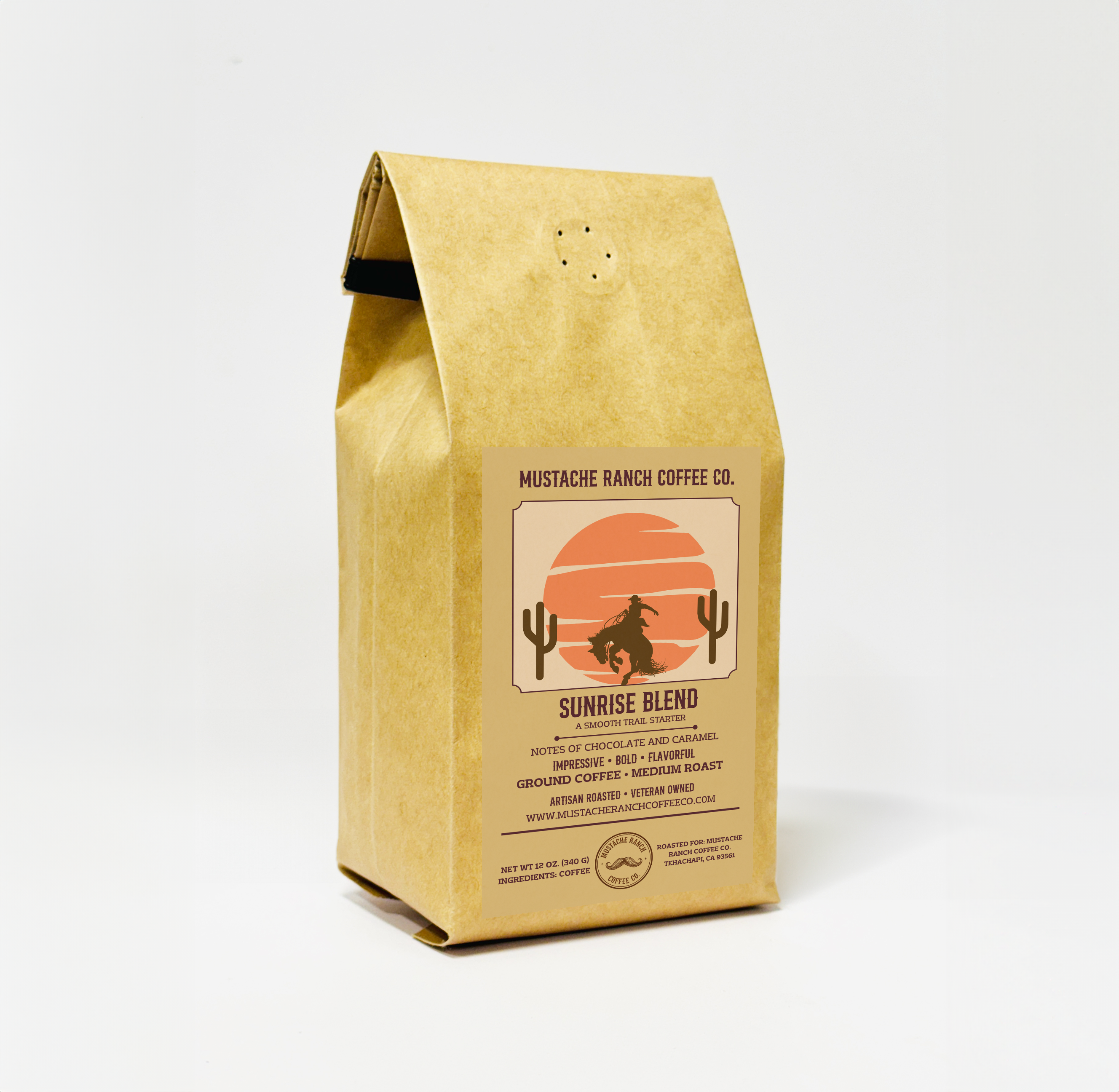 Mustache Ranch Coffee Co. Sunrise Blend coffee in a kraft paper bag with a sunset desert illustration and western branding on a white background.