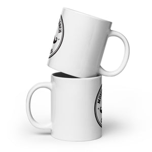 Side view of two white glossy ceramic Mustache Ranch Coffee Co. mugs stacked, with one tilted at an angle, displaying the black logo on a clean white background.